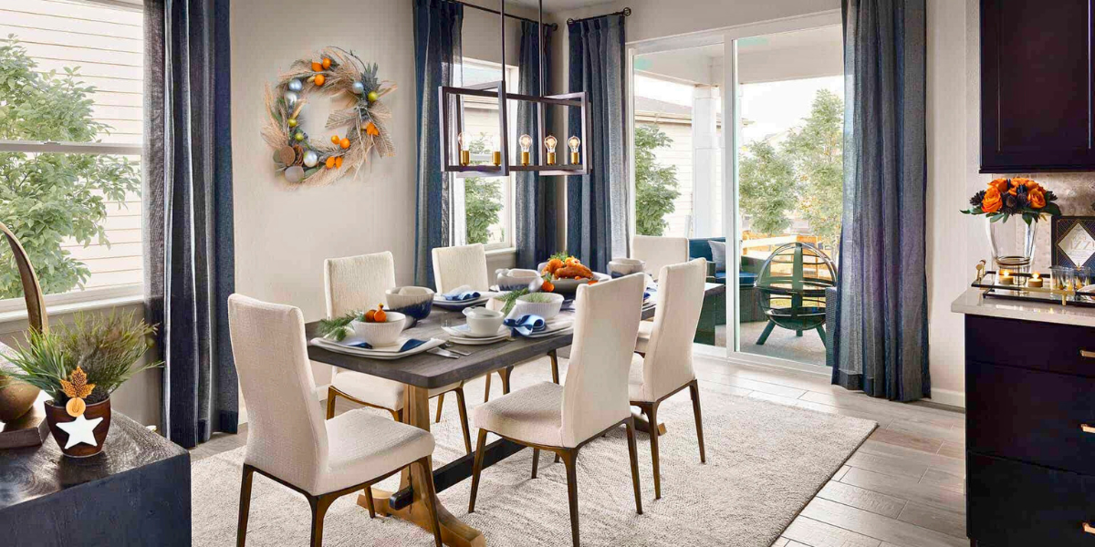 Inside a Tri Pointe Homes dining room with the table set for a fall feast and autumn decorations.