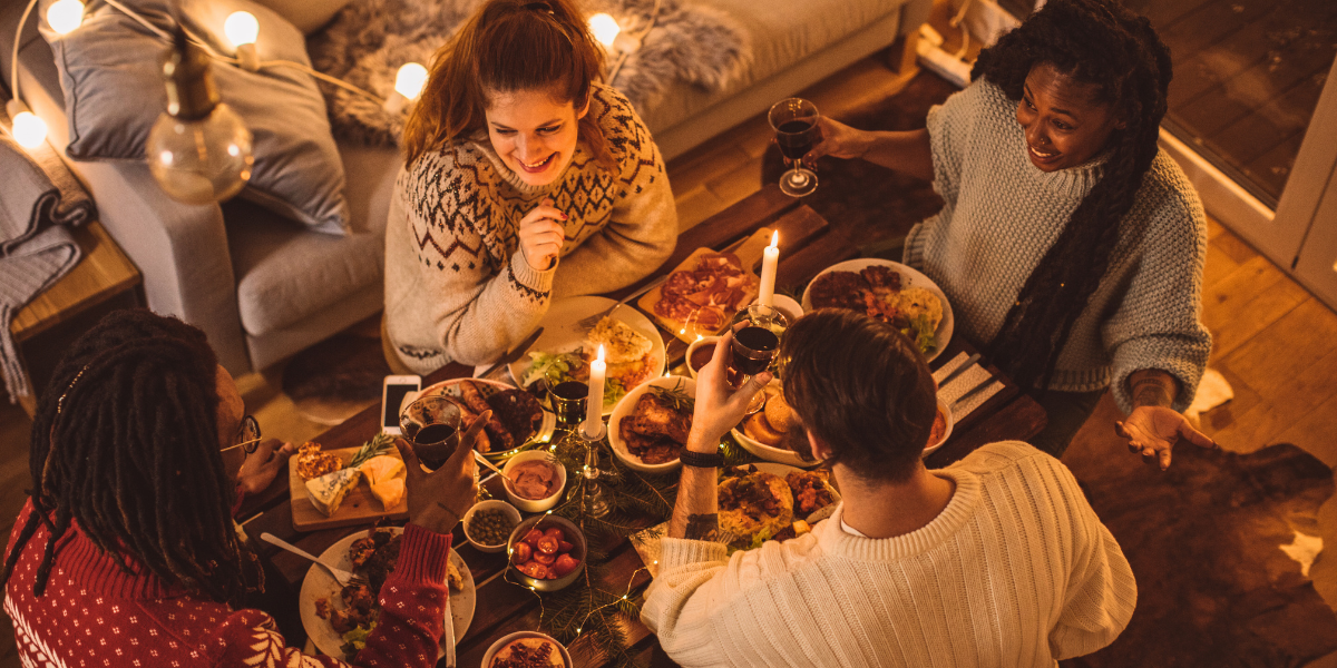 People eating food together in candlelight.