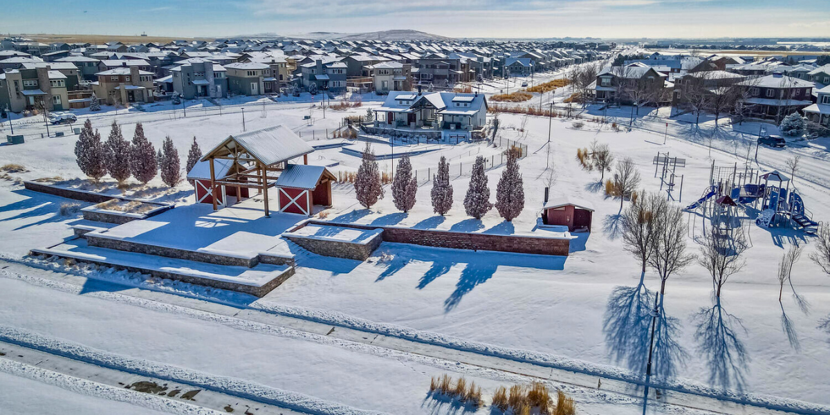 An aerial view of a wintery home community at Reunion in Commerce City, Colorado. 