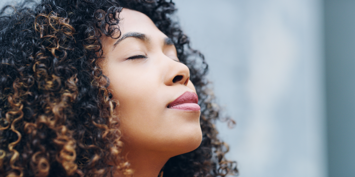 Person with closed eyes being mindful of the moment. 