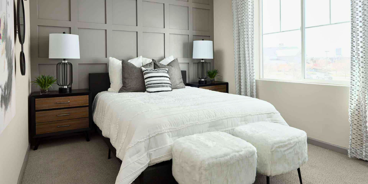 Beautiful bedroom with lots of light coming from large panel windows. 