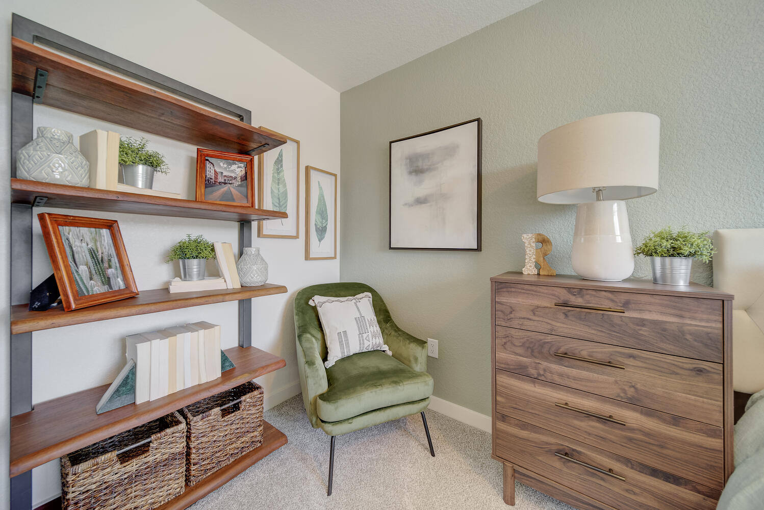 A living space inside an ON2 home with shelves, a chair, and a dresser.