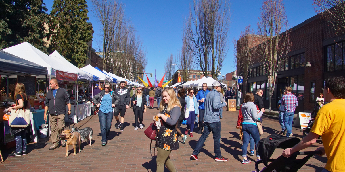 People walking the streets at a farmers' market