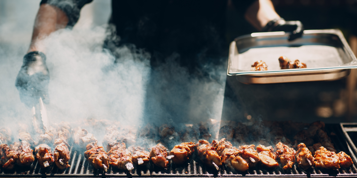Barbecue grill with food sizzling on it.  