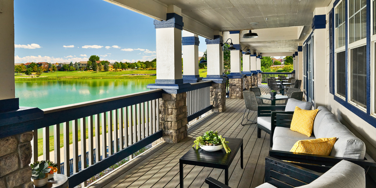Porch view from a coffee house of a beautiful green landscape and blue lake. 