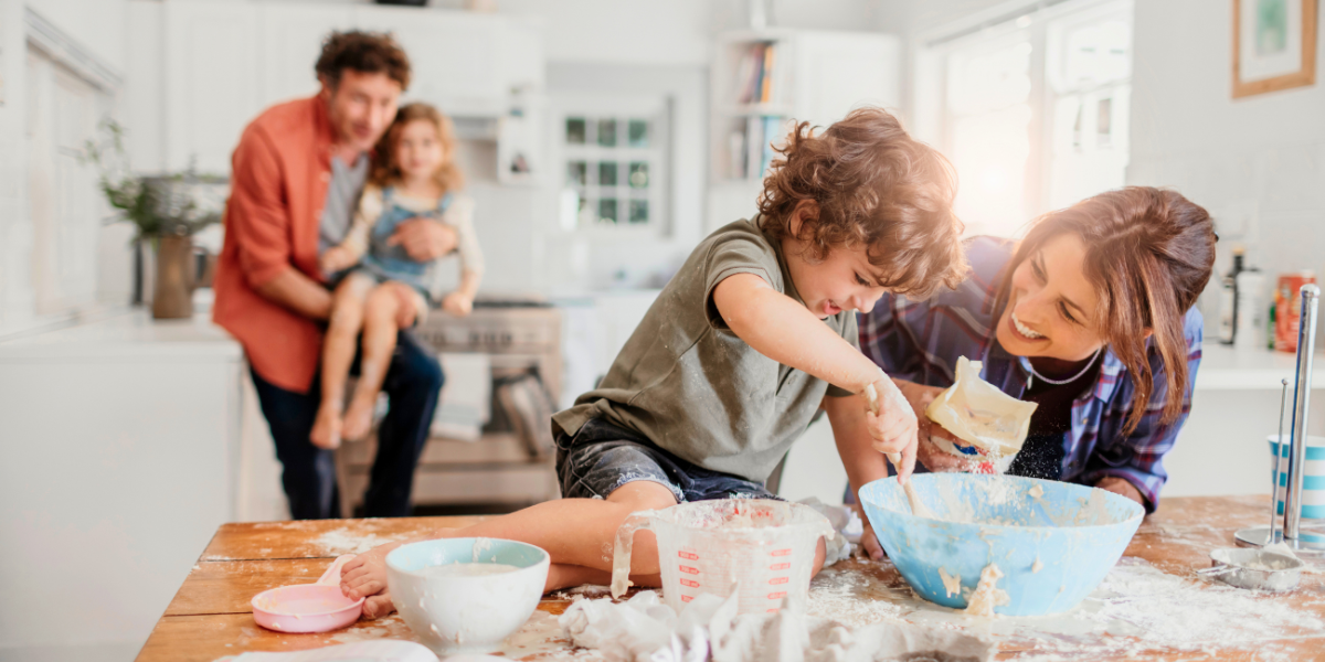A family baking together in a kitchen.