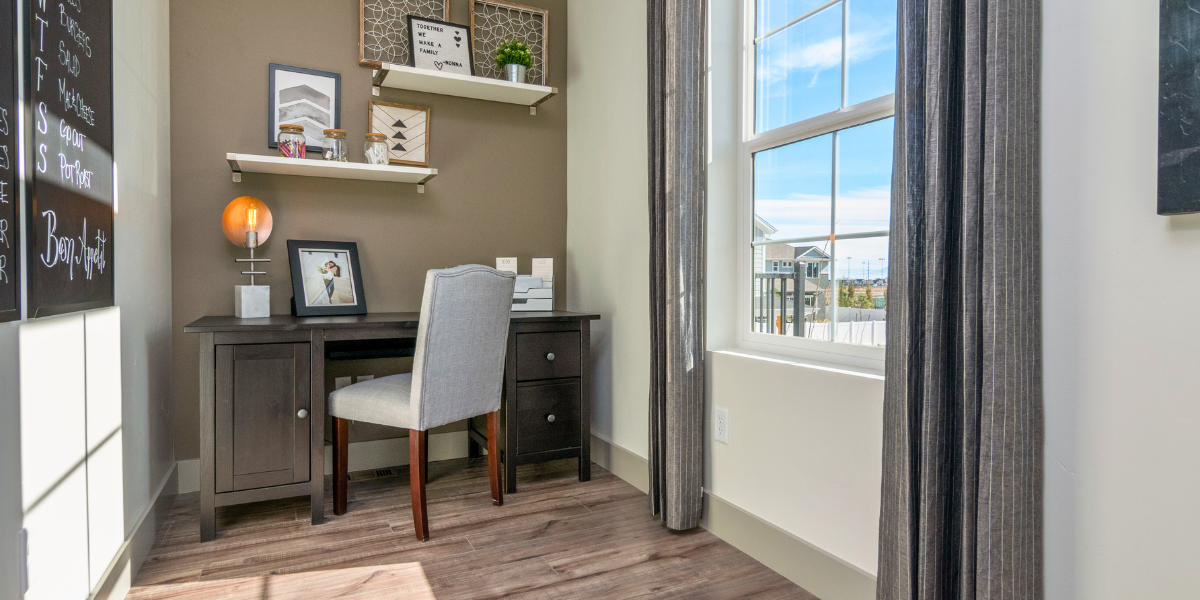 Home office setup with a desk and chair with floating book shelves. 