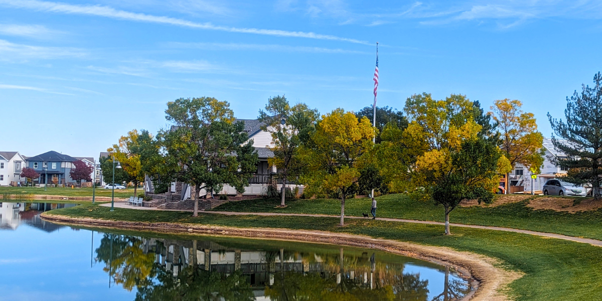 Lake and trees in front of Reunion Rec Center. Your July Home Checklist: Tips for Curb Appeal, Comfort, and Community Connection
