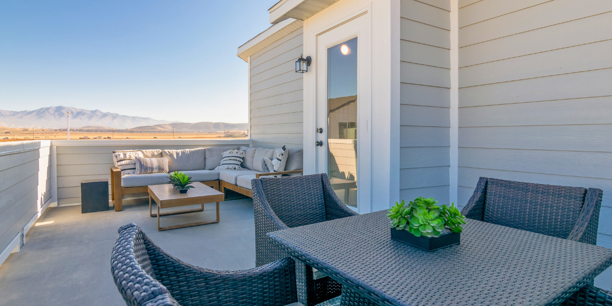 Outdoor rooftop patio with mountains in the back. Your July Home Checklist: Tips for Curb Appeal, Comfort, and Community Connection