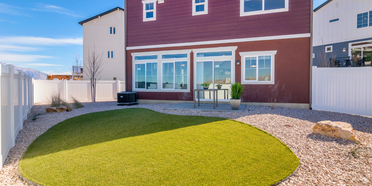 Green lawn in a backyard. Your July Home Checklist: Tips for Curb Appeal, Comfort, and Community Connection