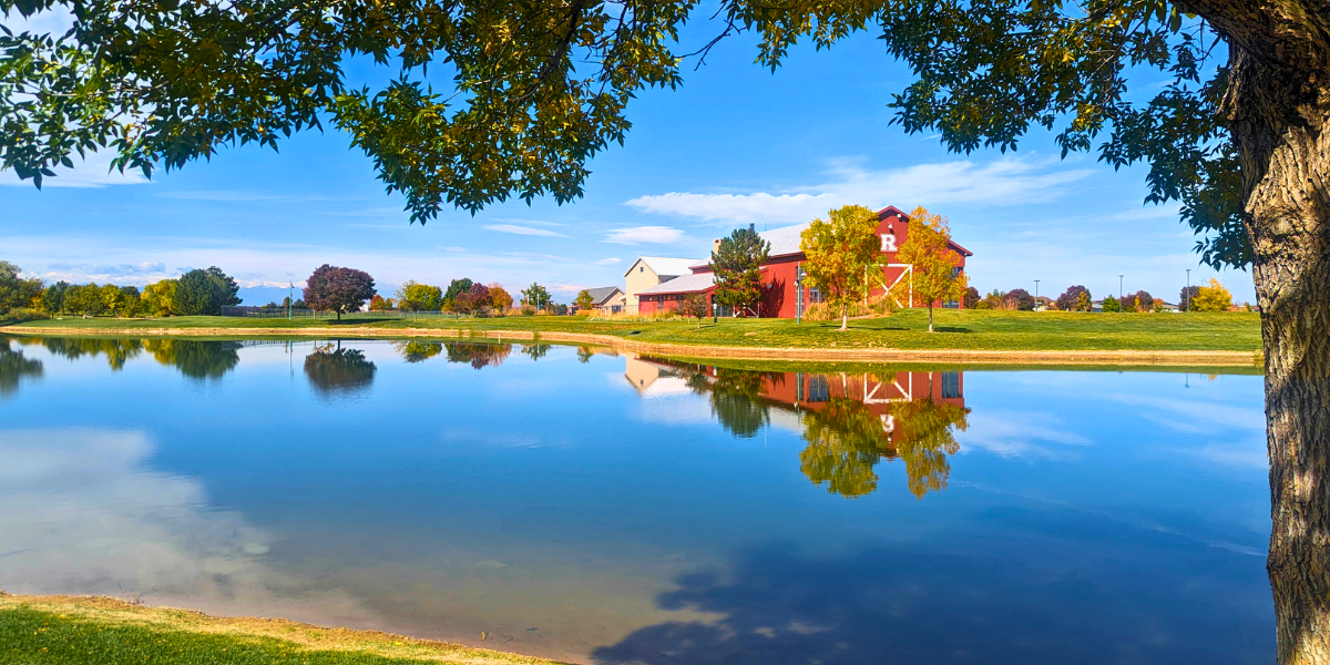 Reunion Rec Center mirrored in lake surrounded by fall foliage.