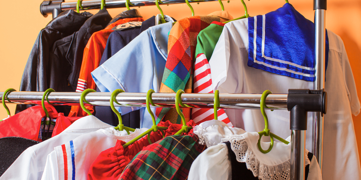 Costumes hanging on a clothing rack.