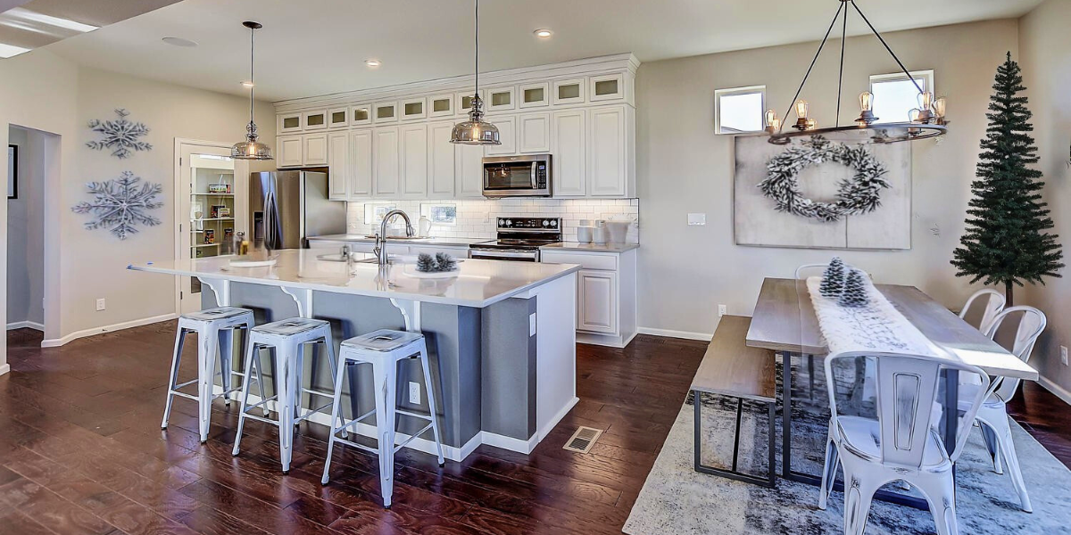 Open kitchen and dining room decorated for the holidays. 