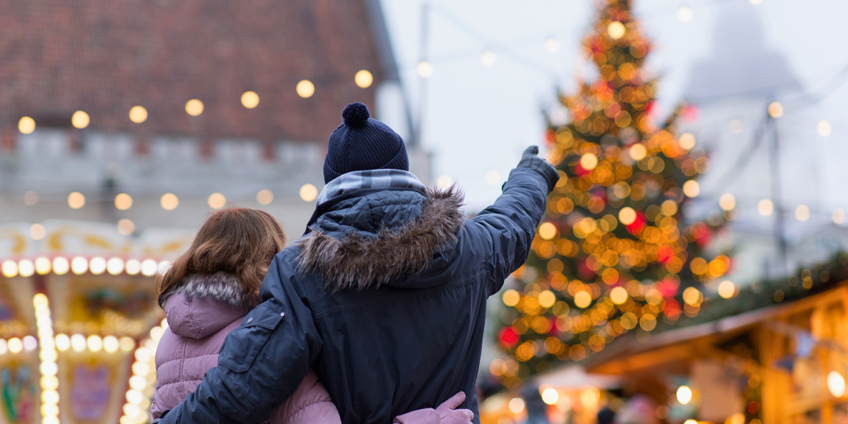 People celebrating outdoors at a winter holiday event.